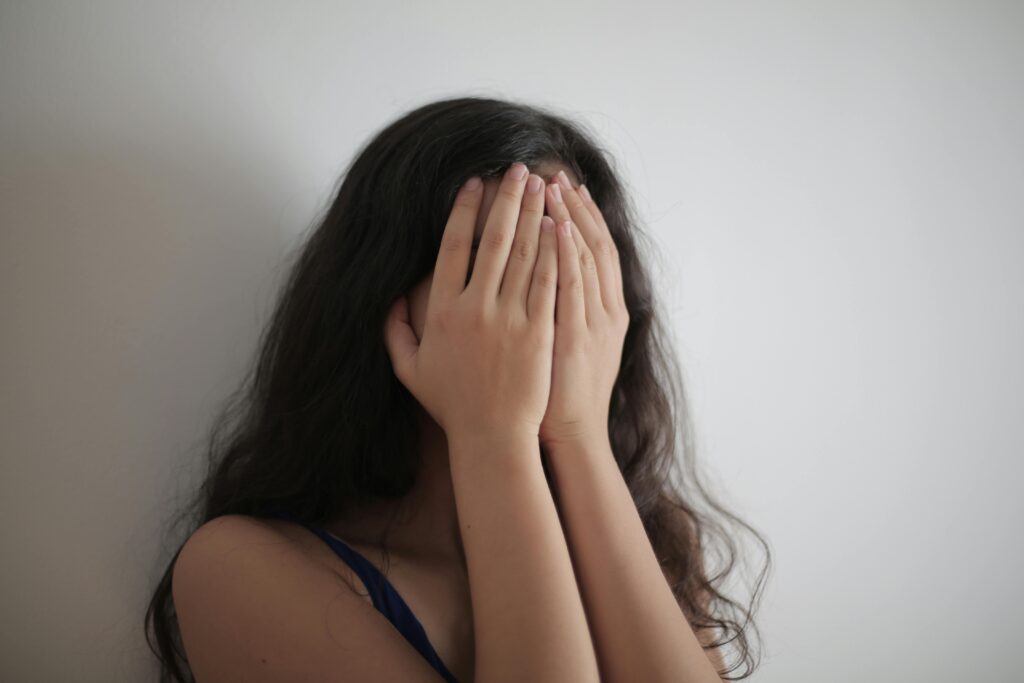 person covering her face