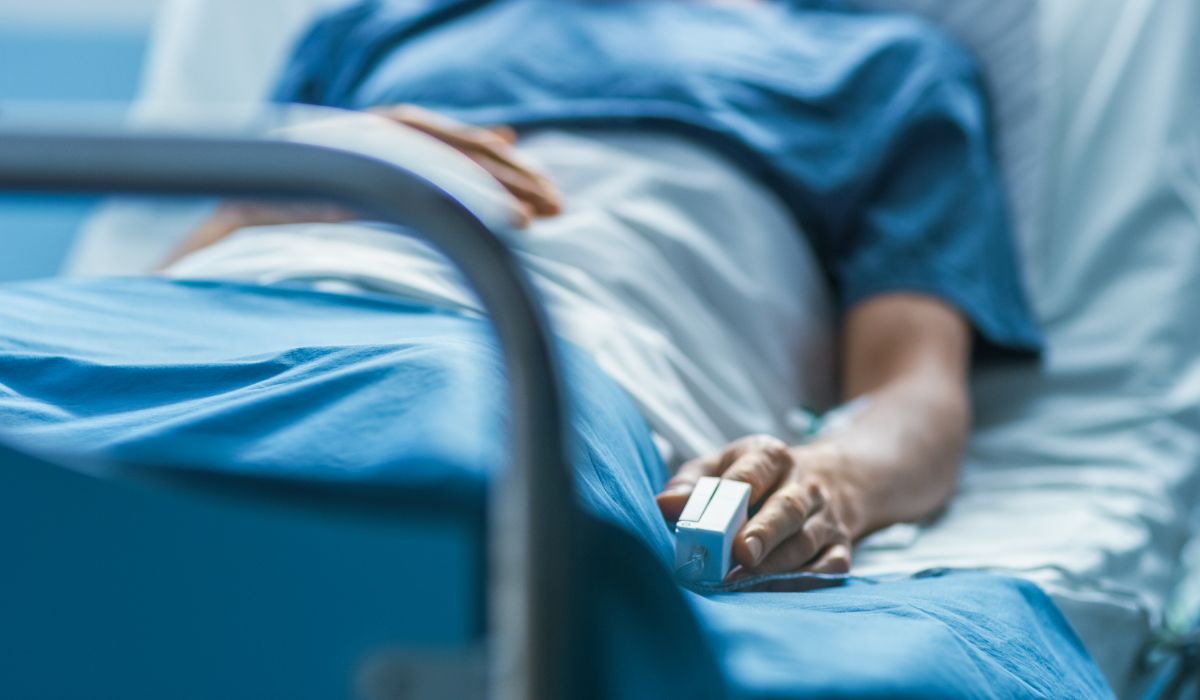 person sitting on hospital bed from opioid withdrawal