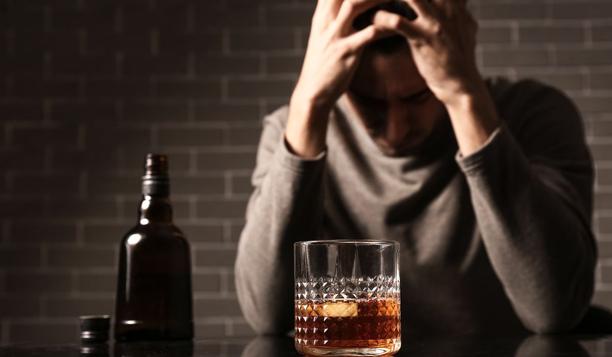 man drinking alcohol at bar