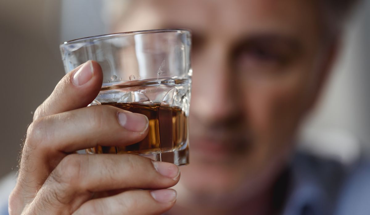 person taking a drink of liquor