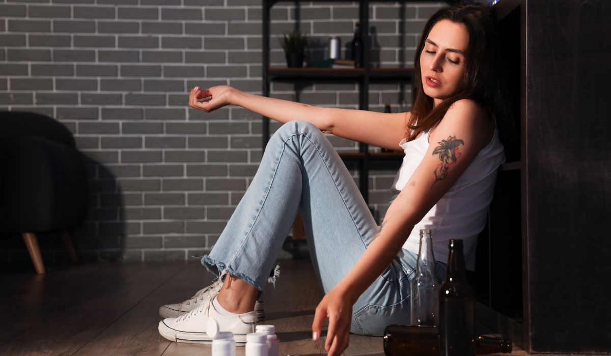 woman having pills while addicted